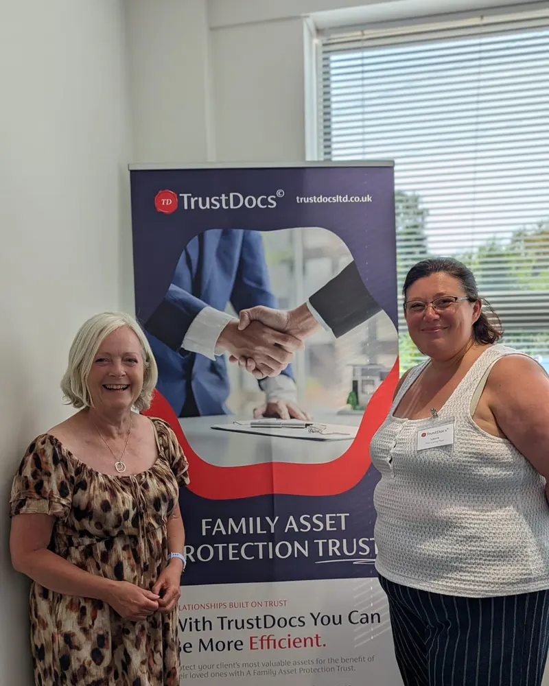 Clare and Laura of Your Living Plan beside the TrustDocs banner after completing the course