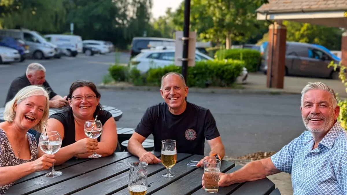 Graduates relaxing together at an outdoor table before the TrustDocs living trust course